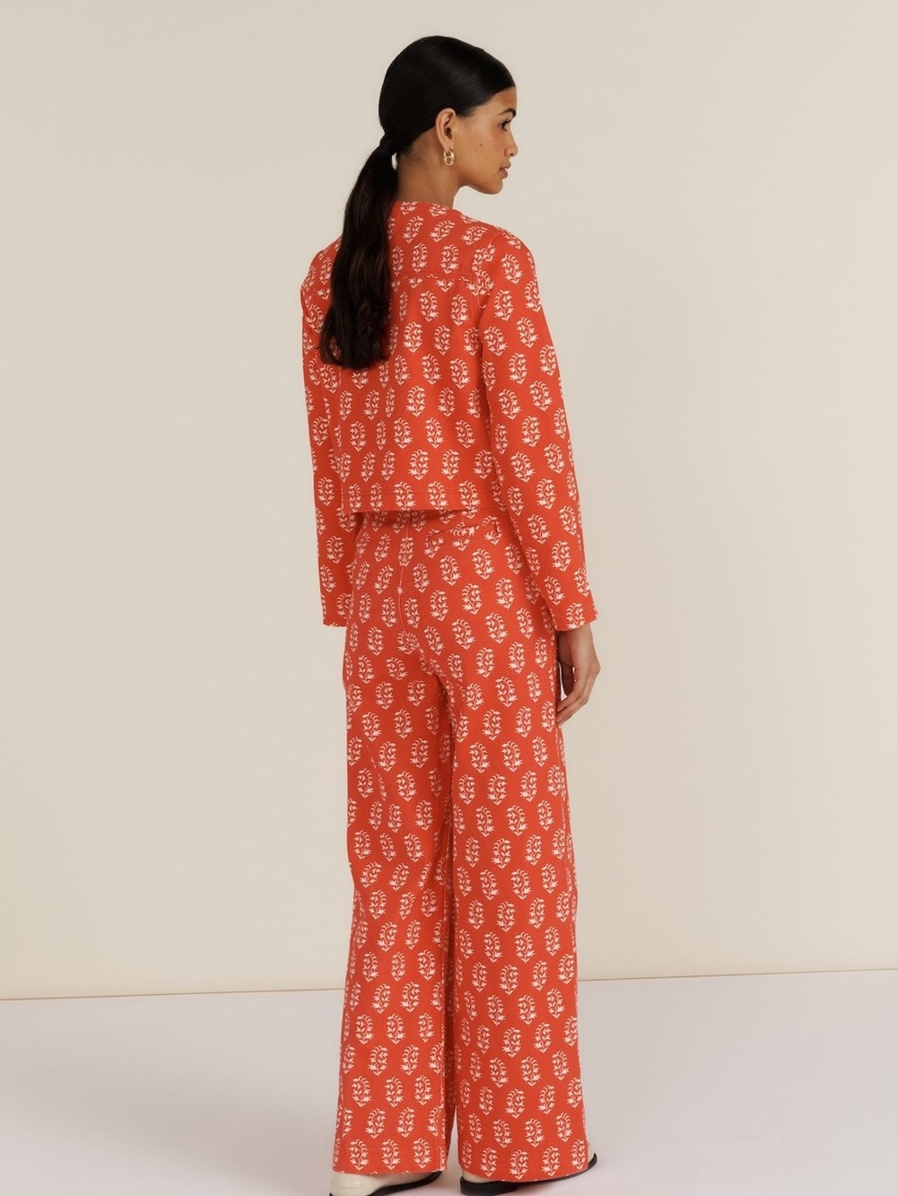 Printed Boot‑Cut Jumpsuit in Coral with Cream Motif